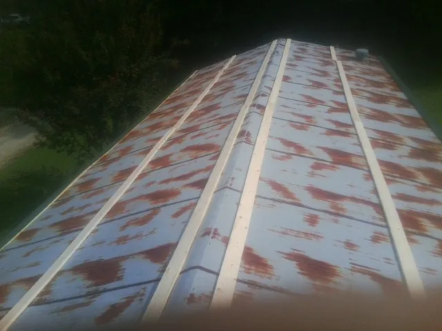 Rusted metal roof panels with new wood purlins before replacement — Storm Damage Roof Repair in Kearneysville by Roofing Brothers