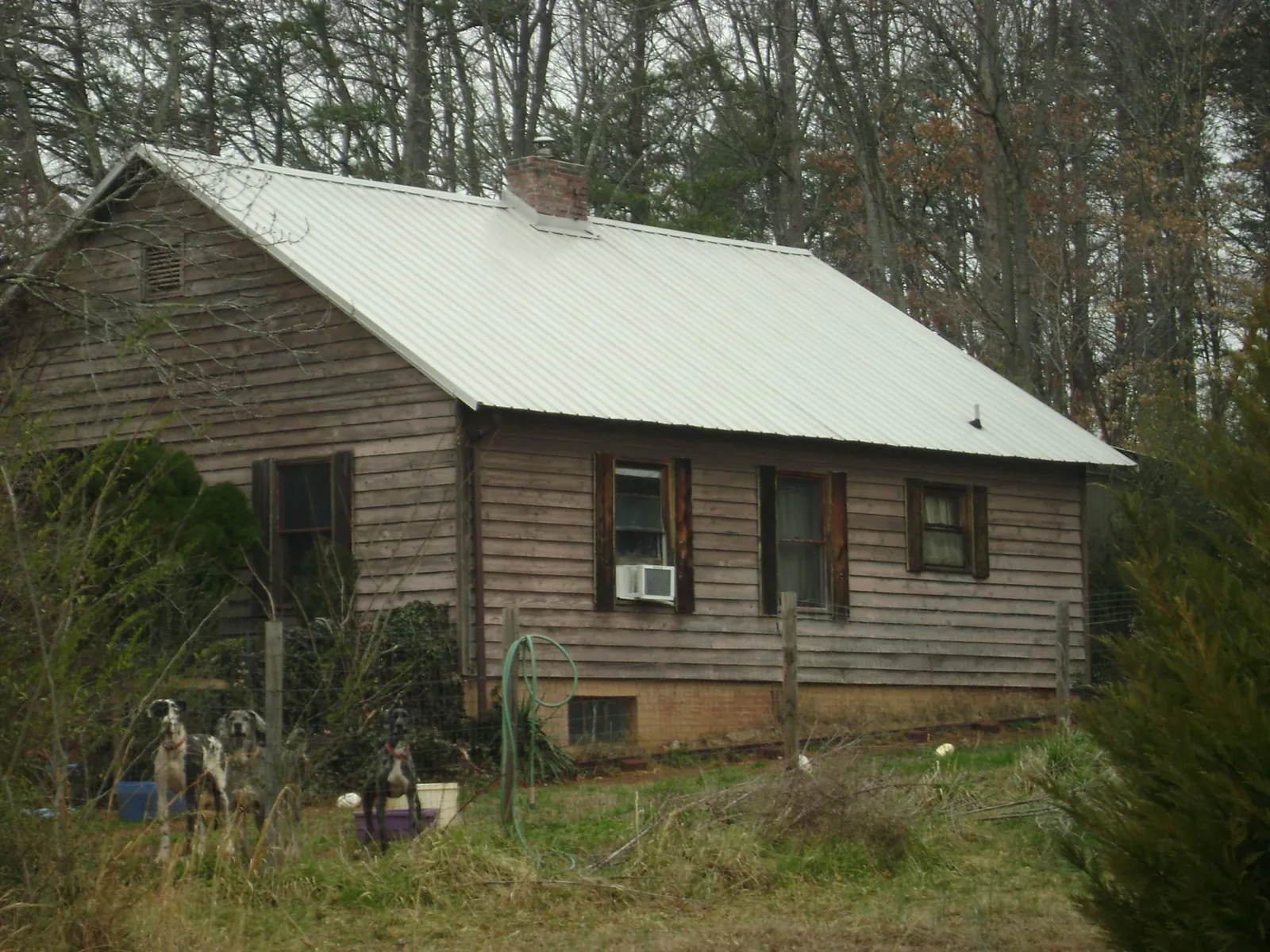 White metal roof on an old wood sided farmhouse, from a Metal Roof Installation job in Kearneysville